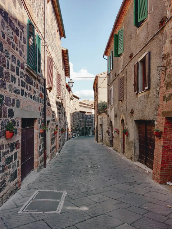 a street with buildings that have green shutters