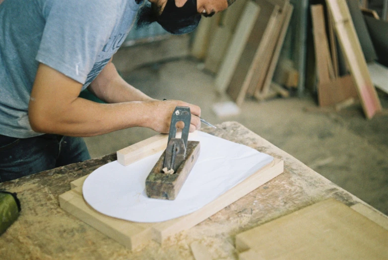 an image of a man holding a tool on a board