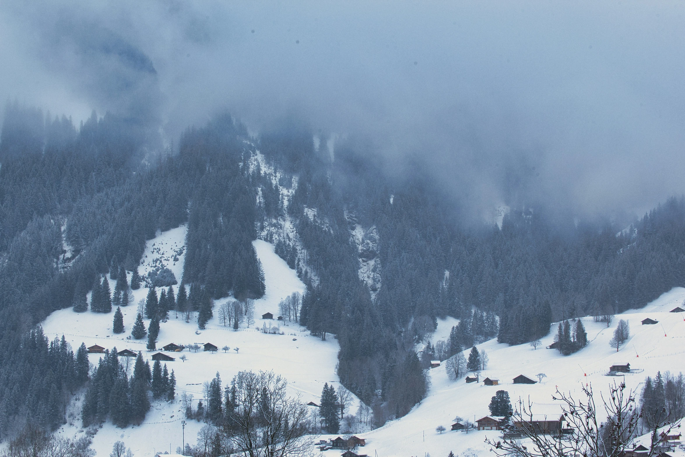 the ski slopes with a lot of snow and clouds on them