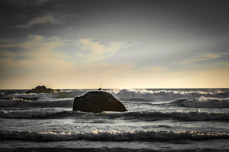 a rock in the middle of a body of water