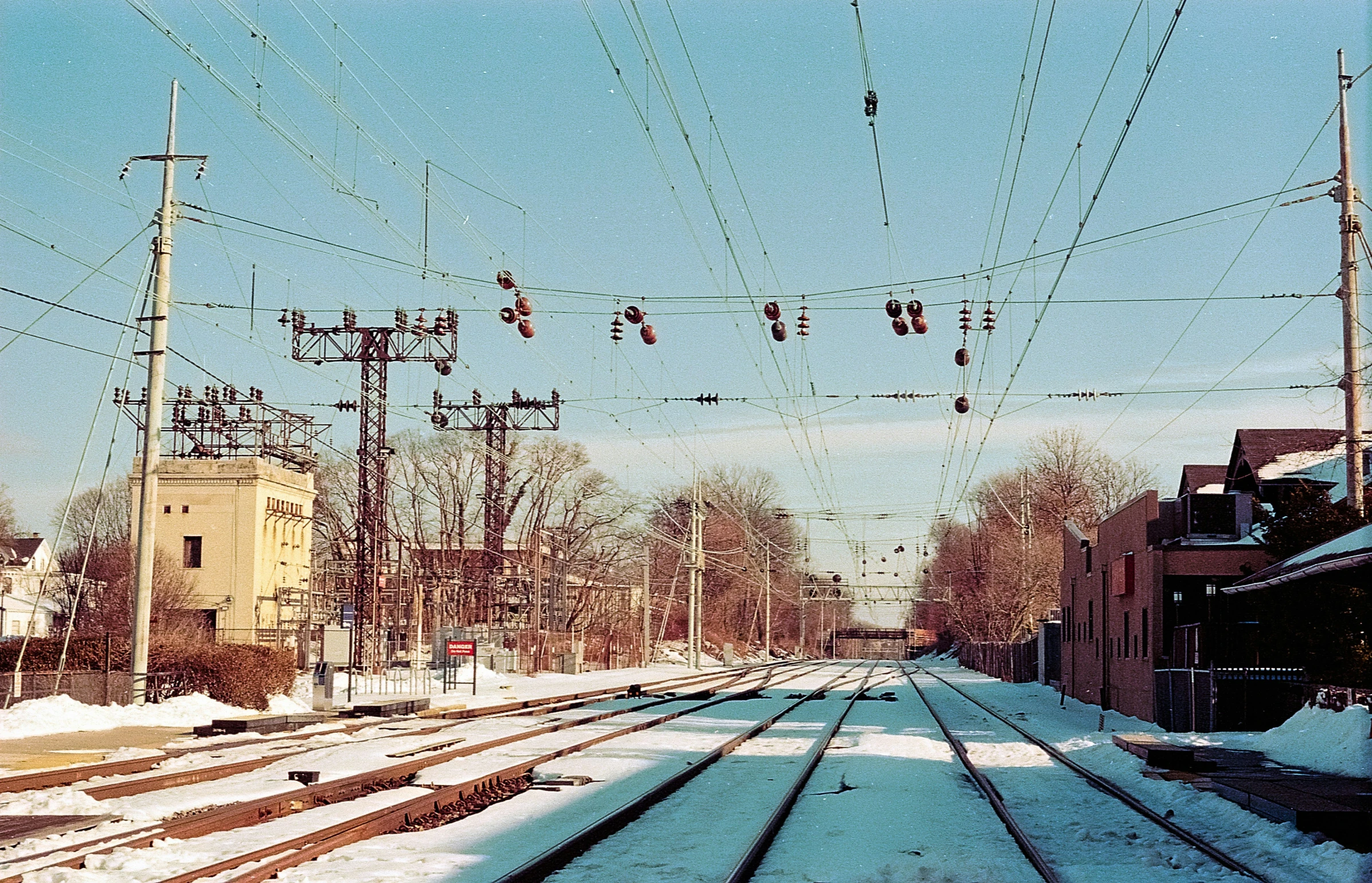 a railroad yard with the light of red on its tracks