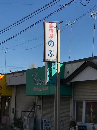 an asian street sign in front of a business