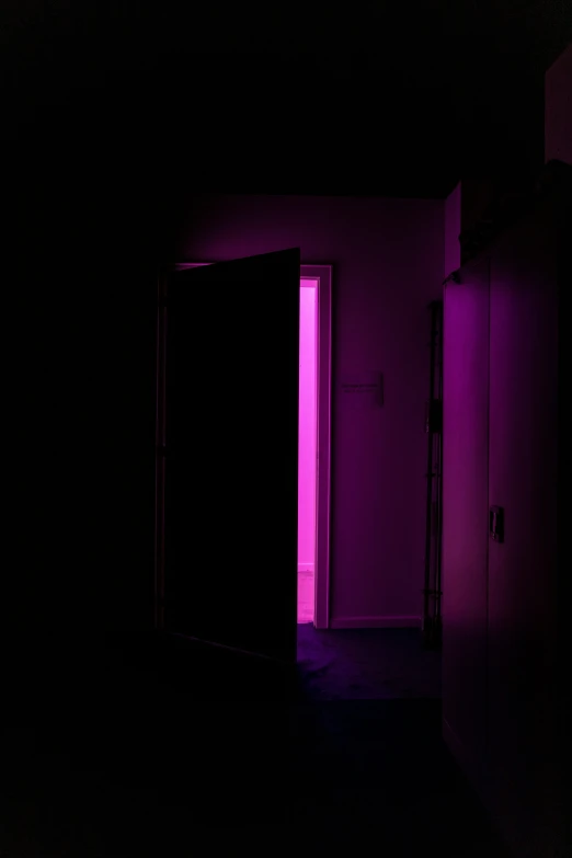 two doors are open in an otherwise dark room