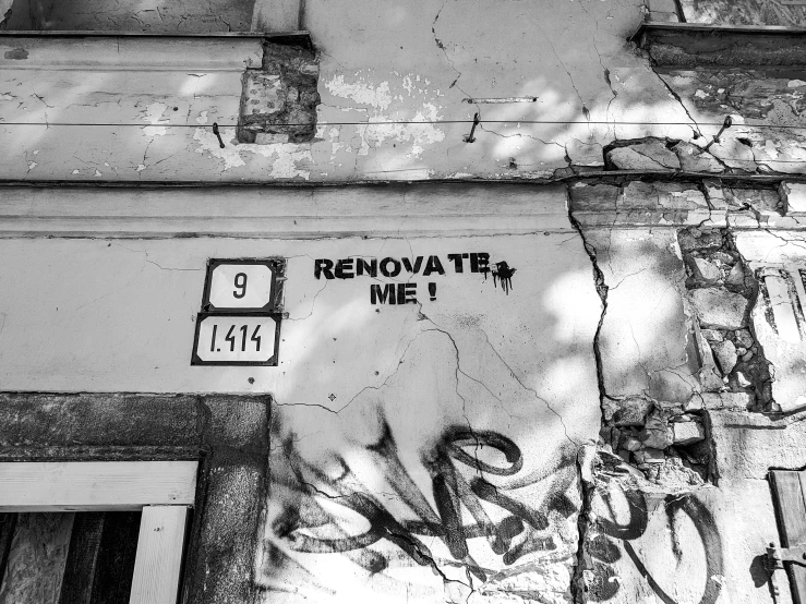 black and white pograph of graffiti on the side of a building