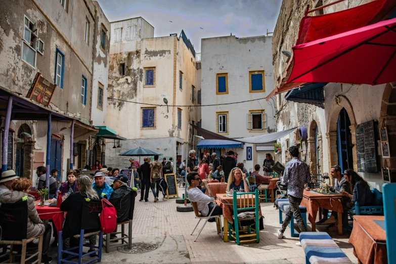 an image of people sitting outside at tables on the patio