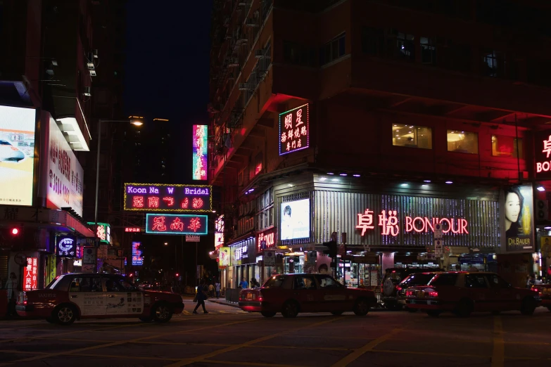 an asian city street with large buildings and neon lights