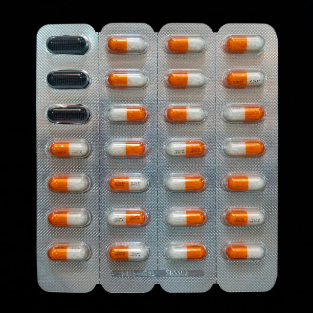 an pills pill pack with two bottles sitting beside it