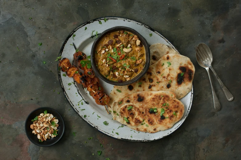 some pita bread on a plate with some dip