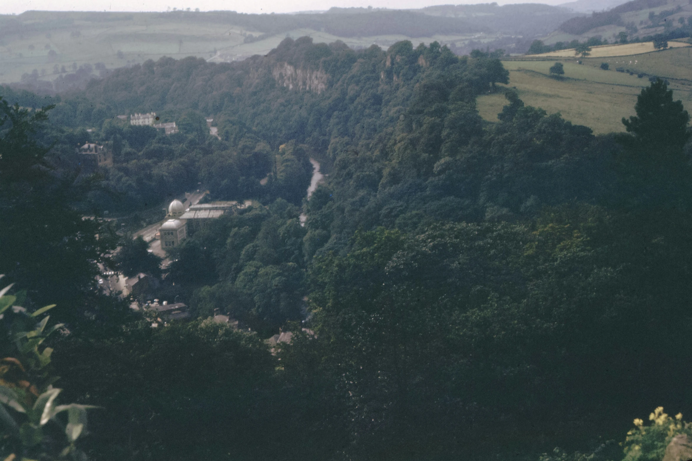 view of town nestled among many hills from above