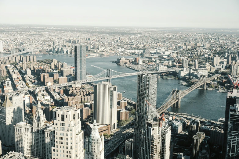 large city buildings in the middle of the city with tall towers and bridge across it