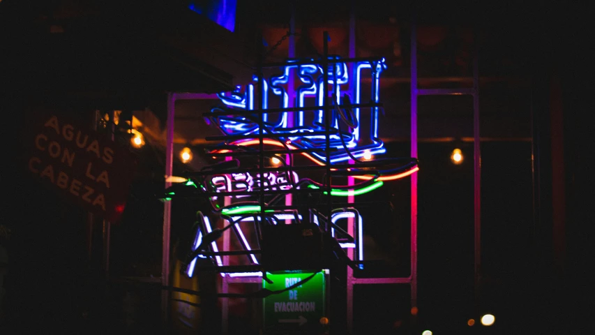 a neon sign that is sitting in the dark