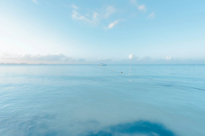 two boats in the water with the sky in the background