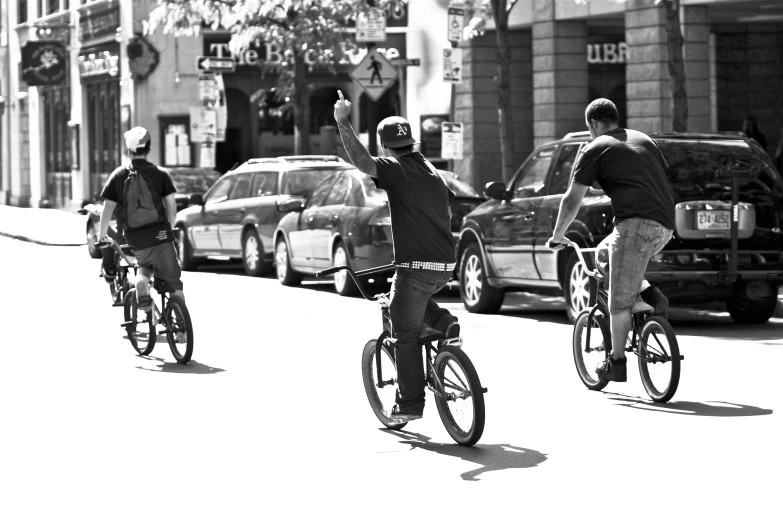 there are three people on bikes riding in the street