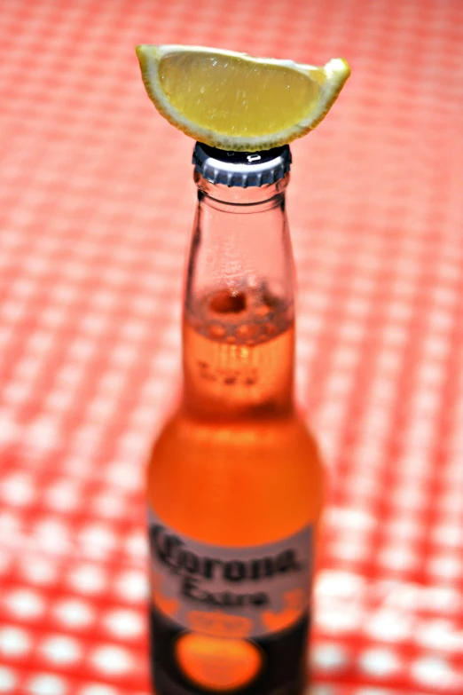 a lemon sitting on top of a glass bottle on a table