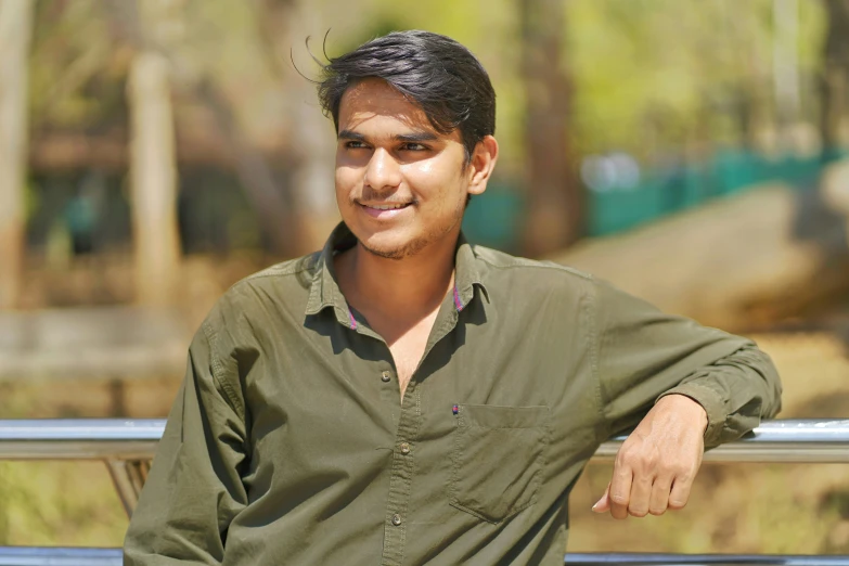 a man standing with his arm crossed behind rail