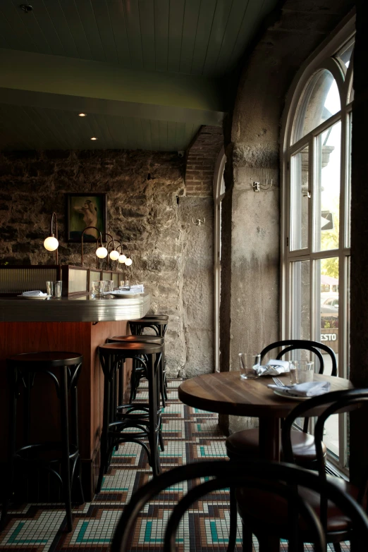 an empty bar area with chairs and tables