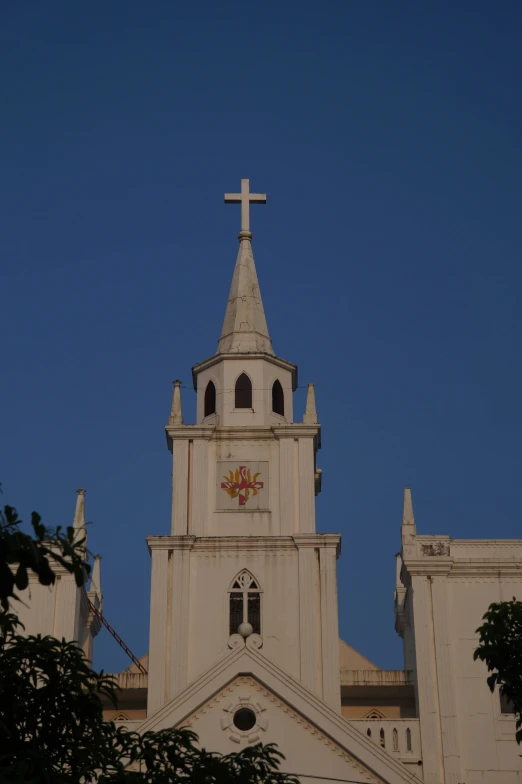 an ornate church with a cross on the front