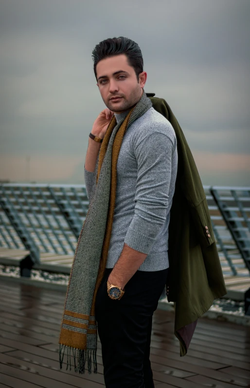 a man that is holding some kind of scarf