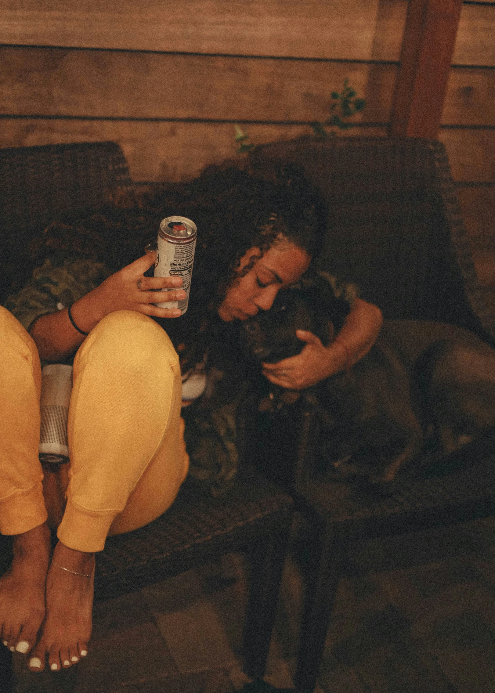 a woman that is laying down holding a can