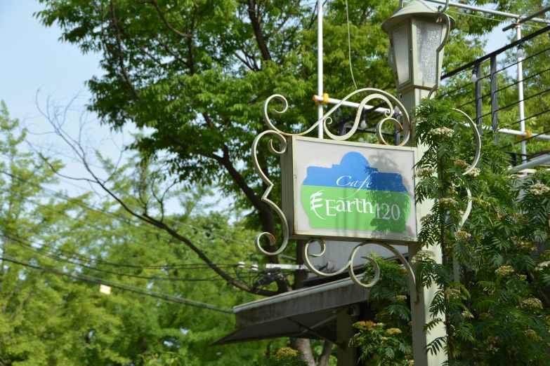 a white sign that reads eat and drink next to some trees