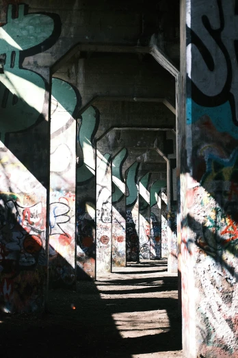 a group of graffiti - covered arches with steps underneath