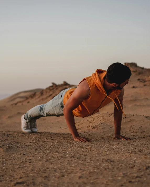 a young man doing h - ups in the desert