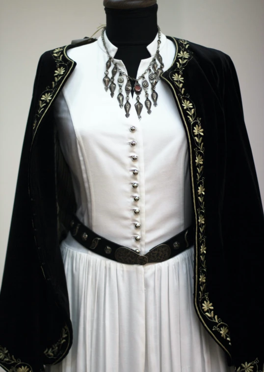 a dress with an open front and a black coat on it