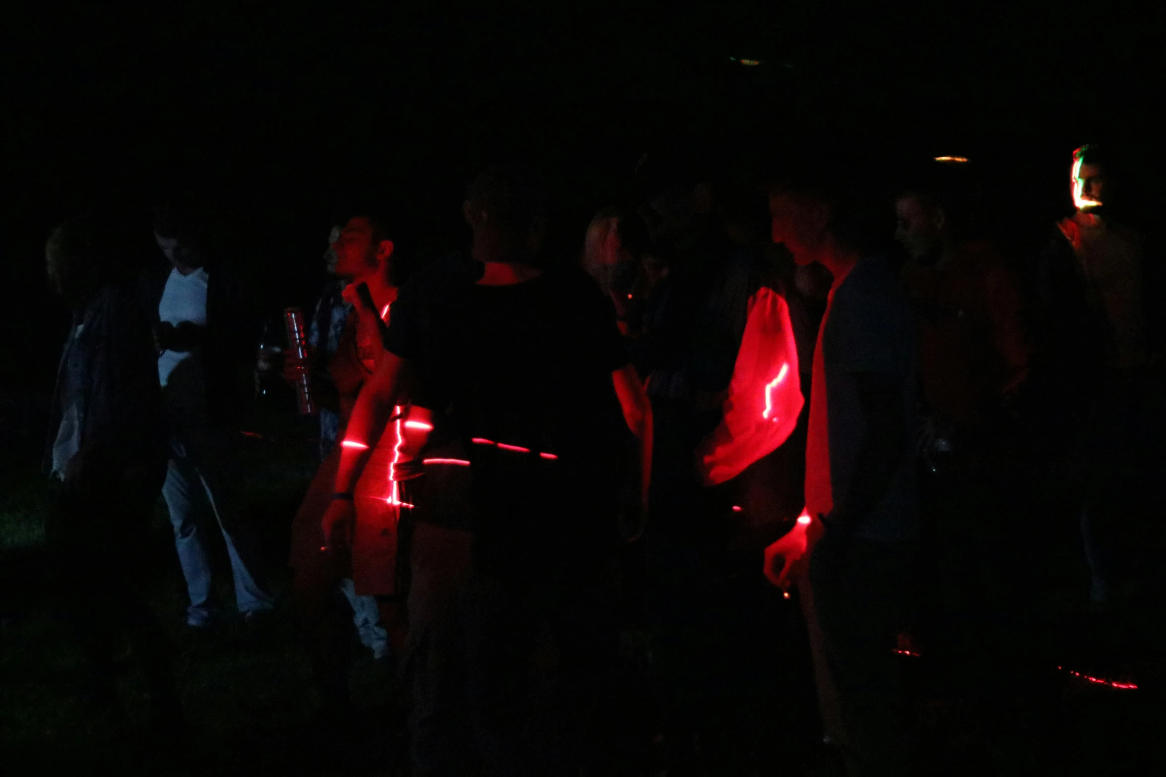 people in the dark with their vests wrapped around