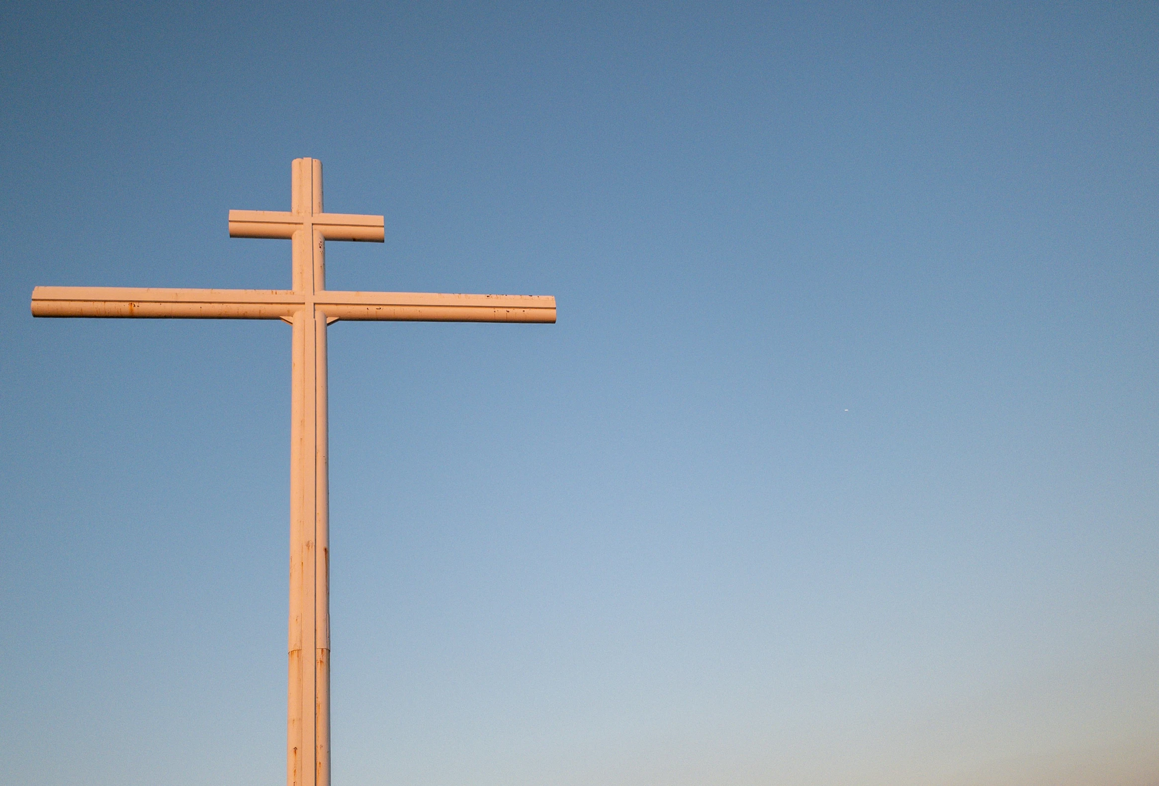 an image of a cross that is high in the sky
