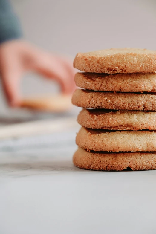 the stack of cookies has a big bite taken out of one