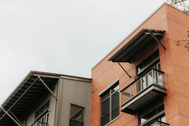 there are some red brick buildings with a balcony