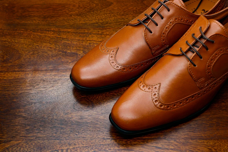 two men's shoes on top of a table