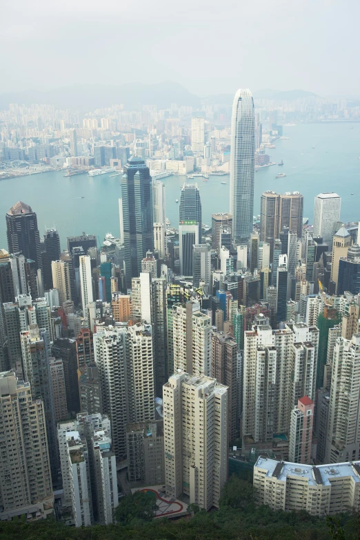 many different colored buildings with a large body of water behind them