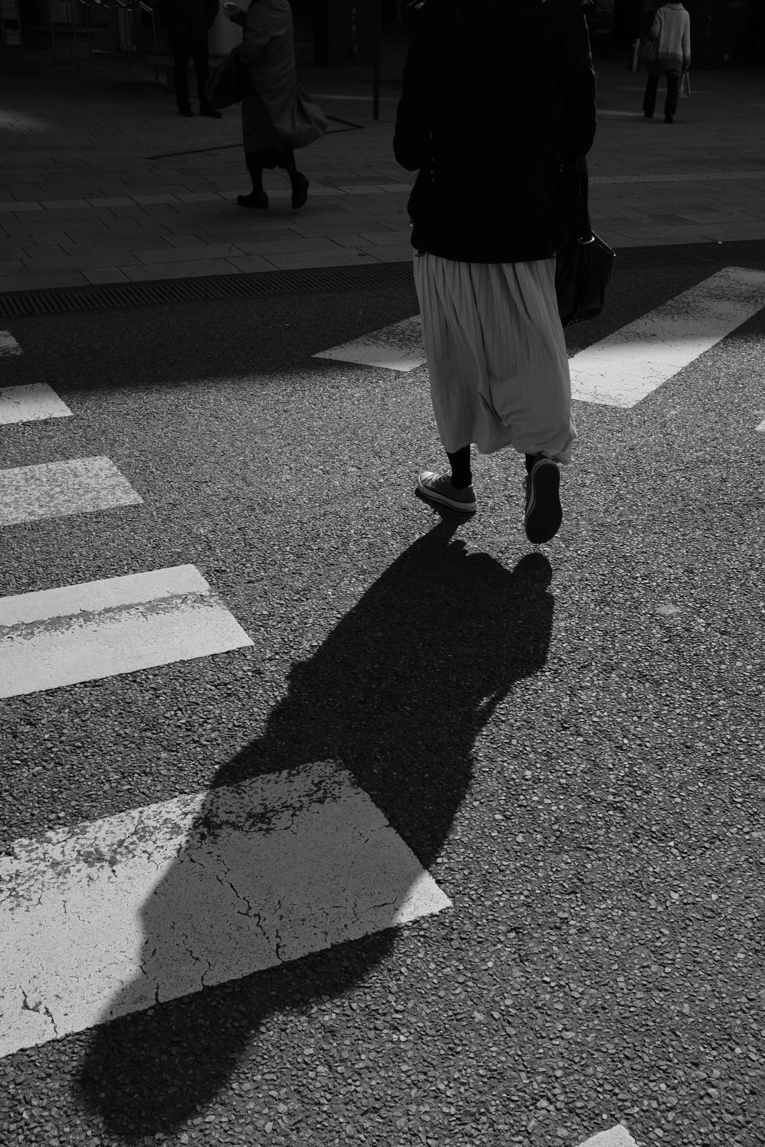 a man standing next to a cross walk on a street