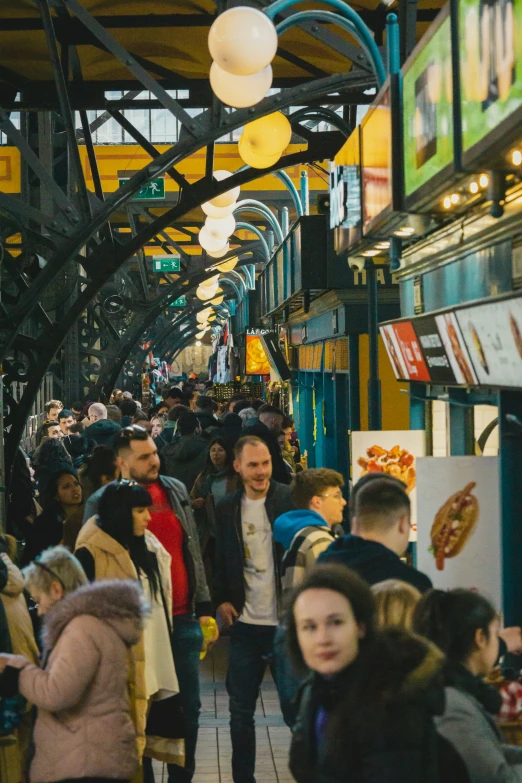 a large crowd of people standing around a city street