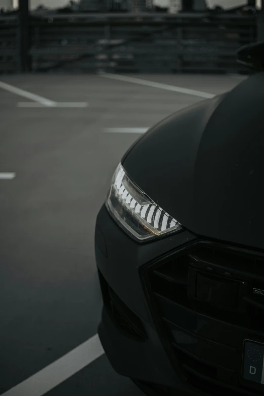 a sleek black car driving on a street