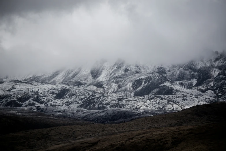 a mountain with a dark sky in the background