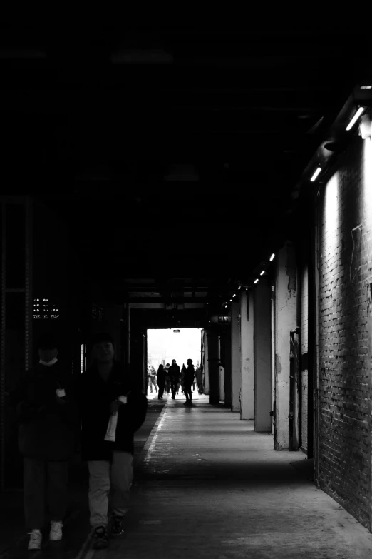 black and white po of people walking down sidewalk
