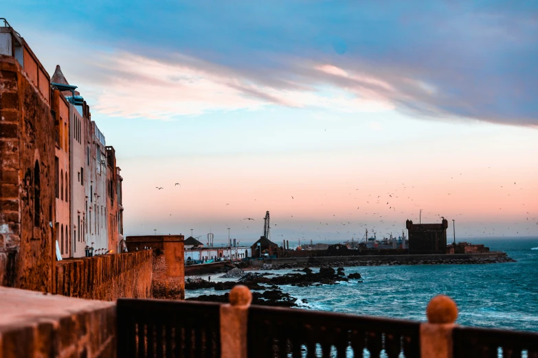 a view of the sea with a few birds flying over