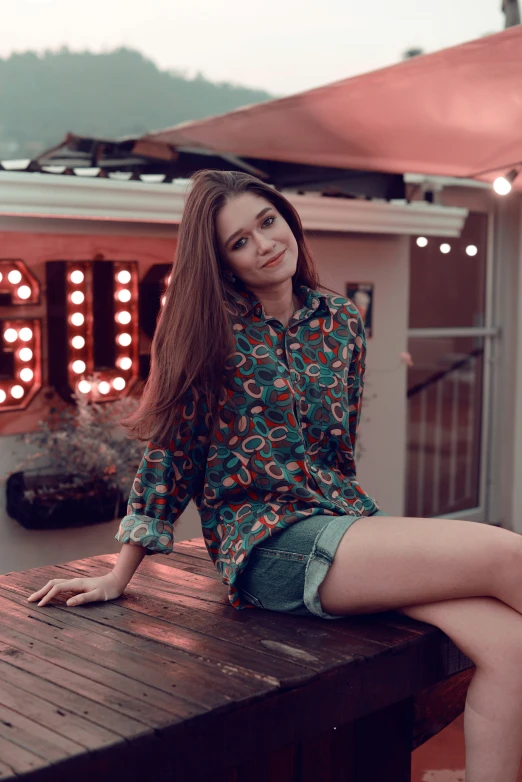 the young woman is sitting on the wooden bench