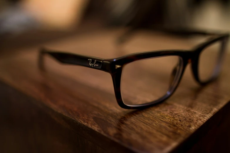 the glasses are resting on a wooden table