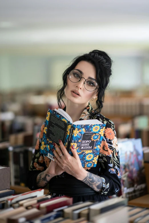 the woman with the glasses is reading a book