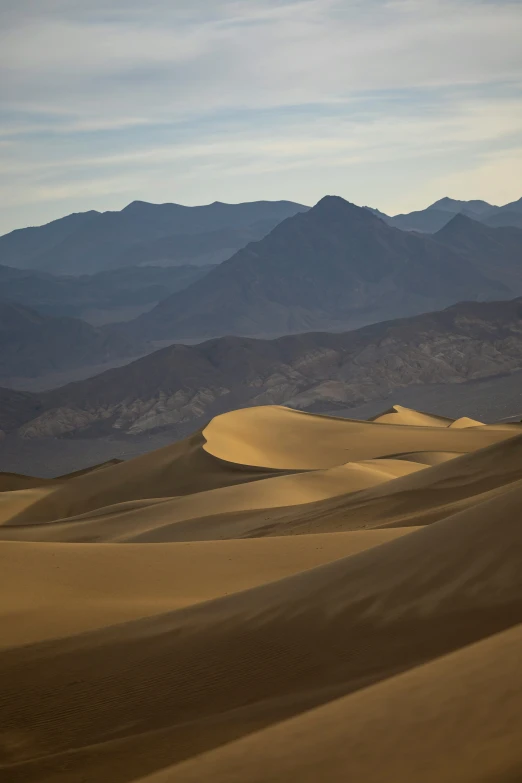 dunes and mountains at the bottom of an arid valley