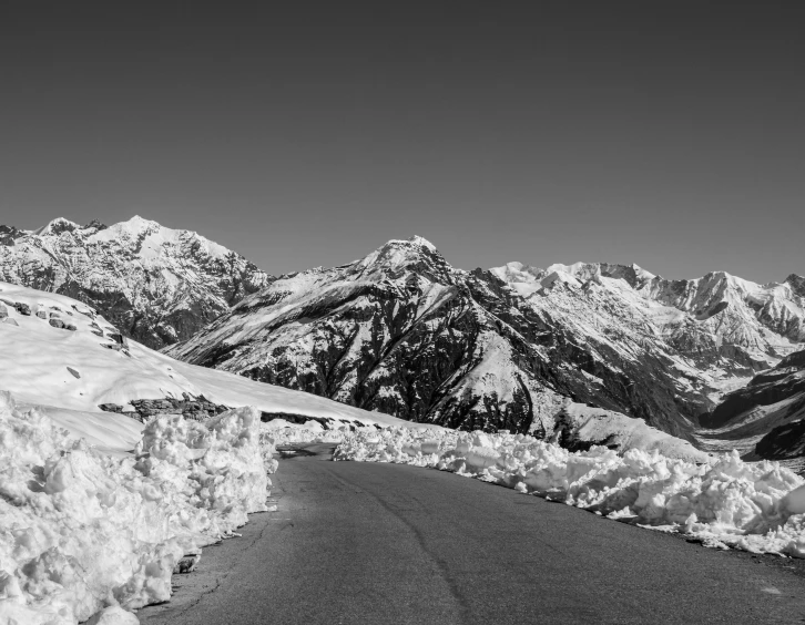 the snow is covered in thick snow as there are mountains in the background