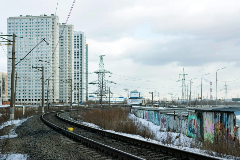 a train traveling past tall buildings in a city