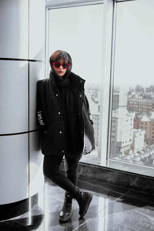 woman standing in front of window with sunglasses on