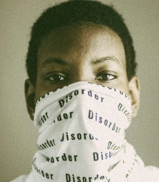 an african american young woman covering her face