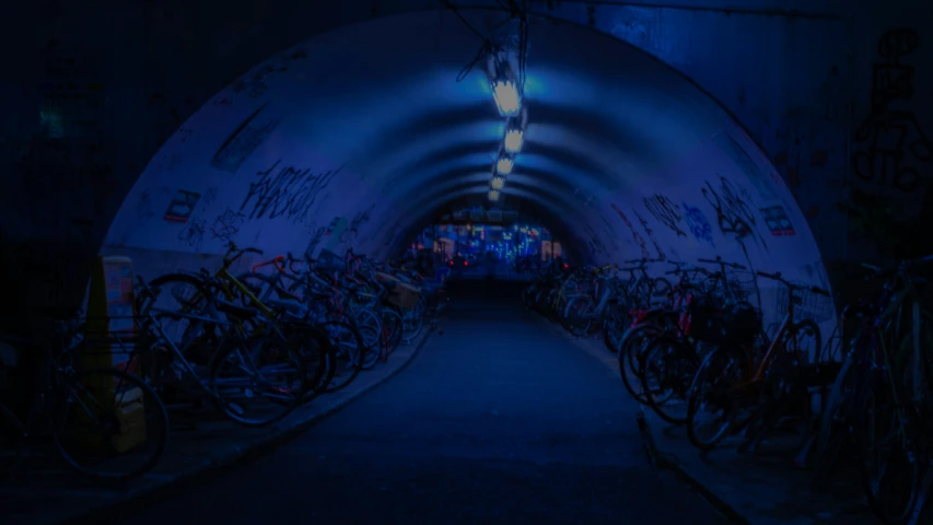 bicycles are in a tunnel with a blue light