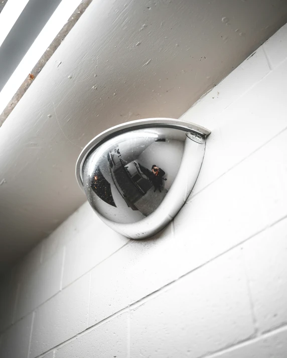 an illuminated mirror is reflecting a man outside