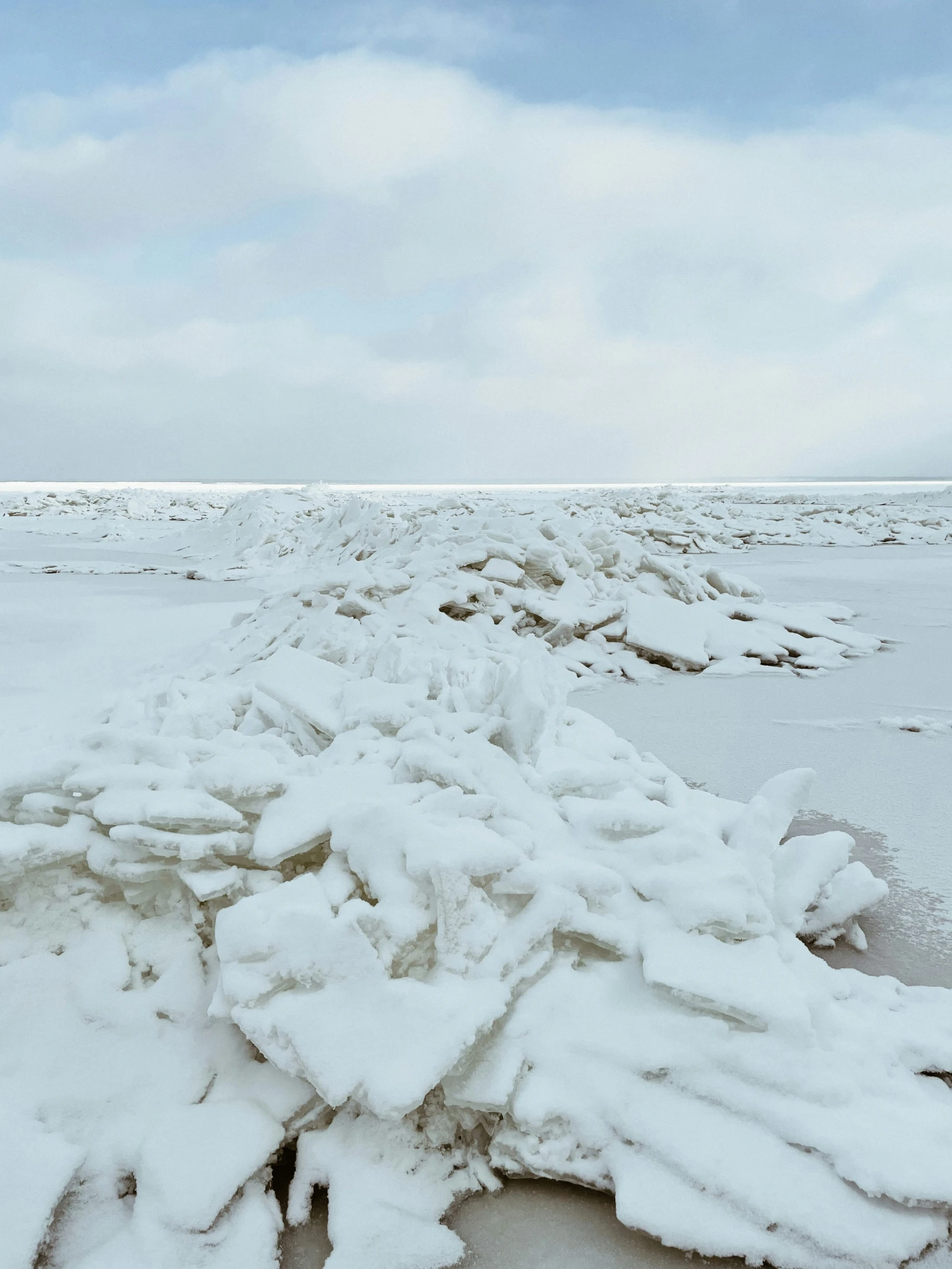 snow drifts on the ground during the day